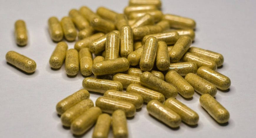 a pile of yellow pills sitting on top of a table