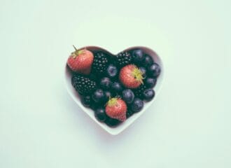 heart-shaped bowl with strawberries