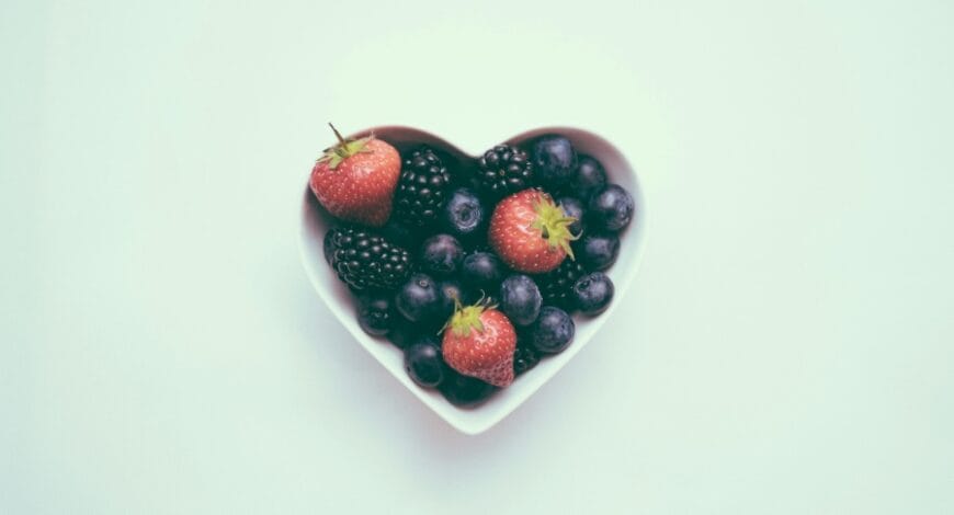 heart-shaped bowl with strawberries