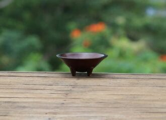 A small wooden kava bowl