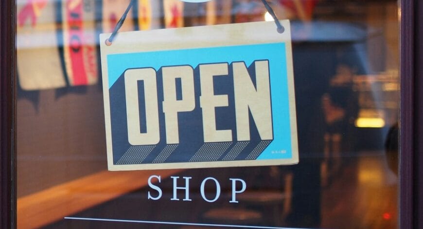 Glass door of a shop with a blue Open sign